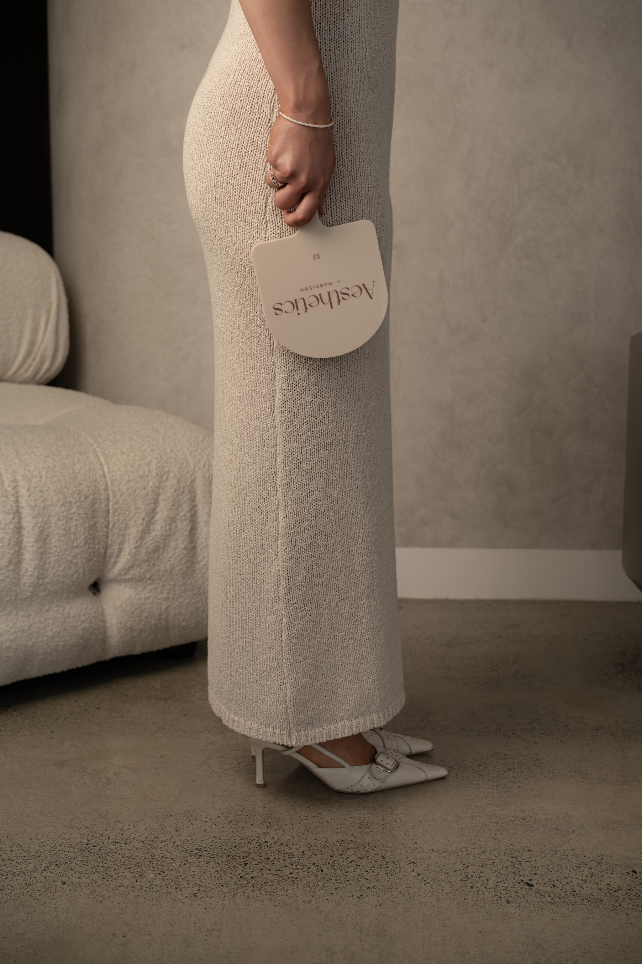 Aesthetics by Maddison. brand swing-tag at hip, cream sweater dress, white pointed-toe heels