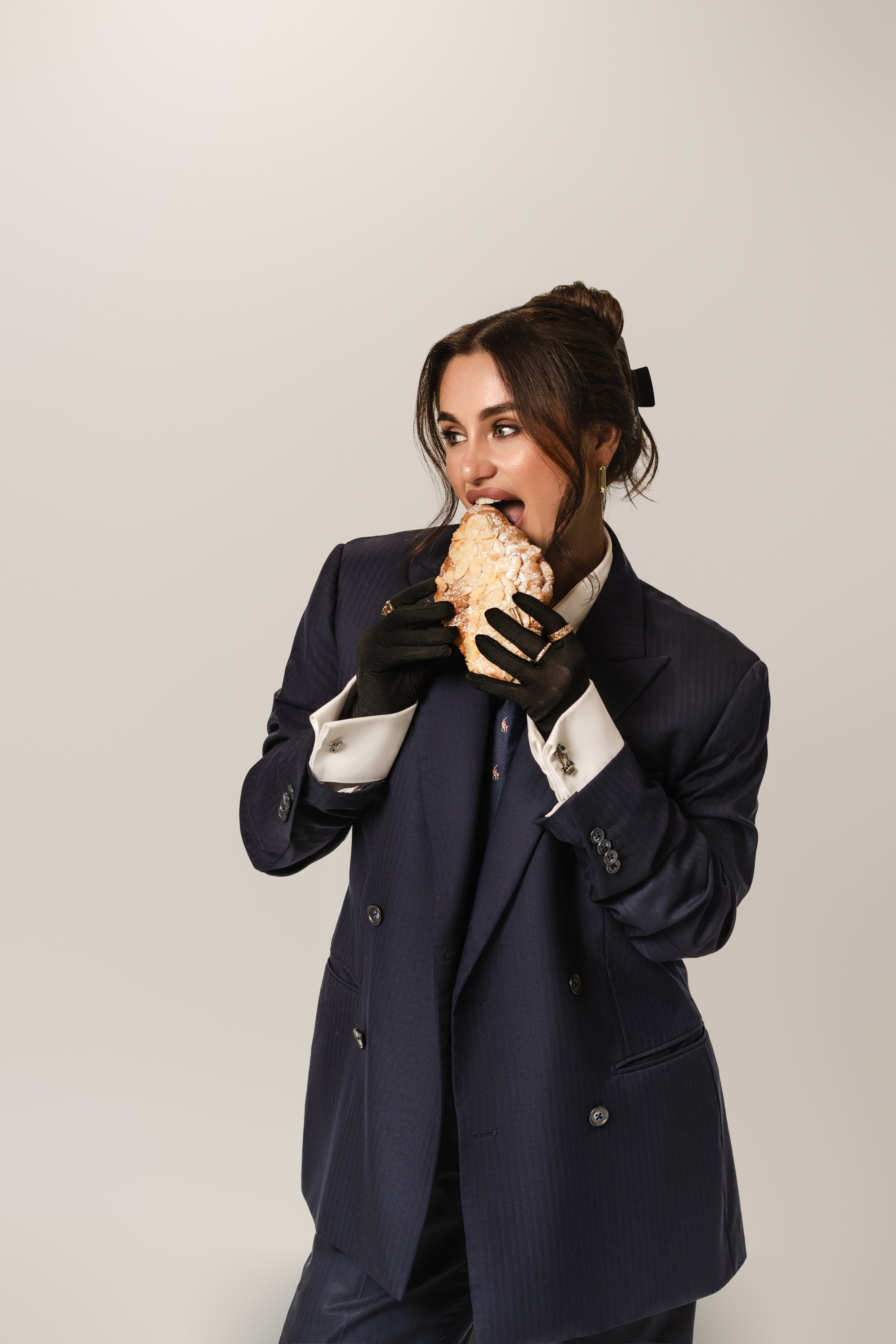 Portrait of Fifi Rochet, photographer behind PLTFRM, in a navy double-breasted suit