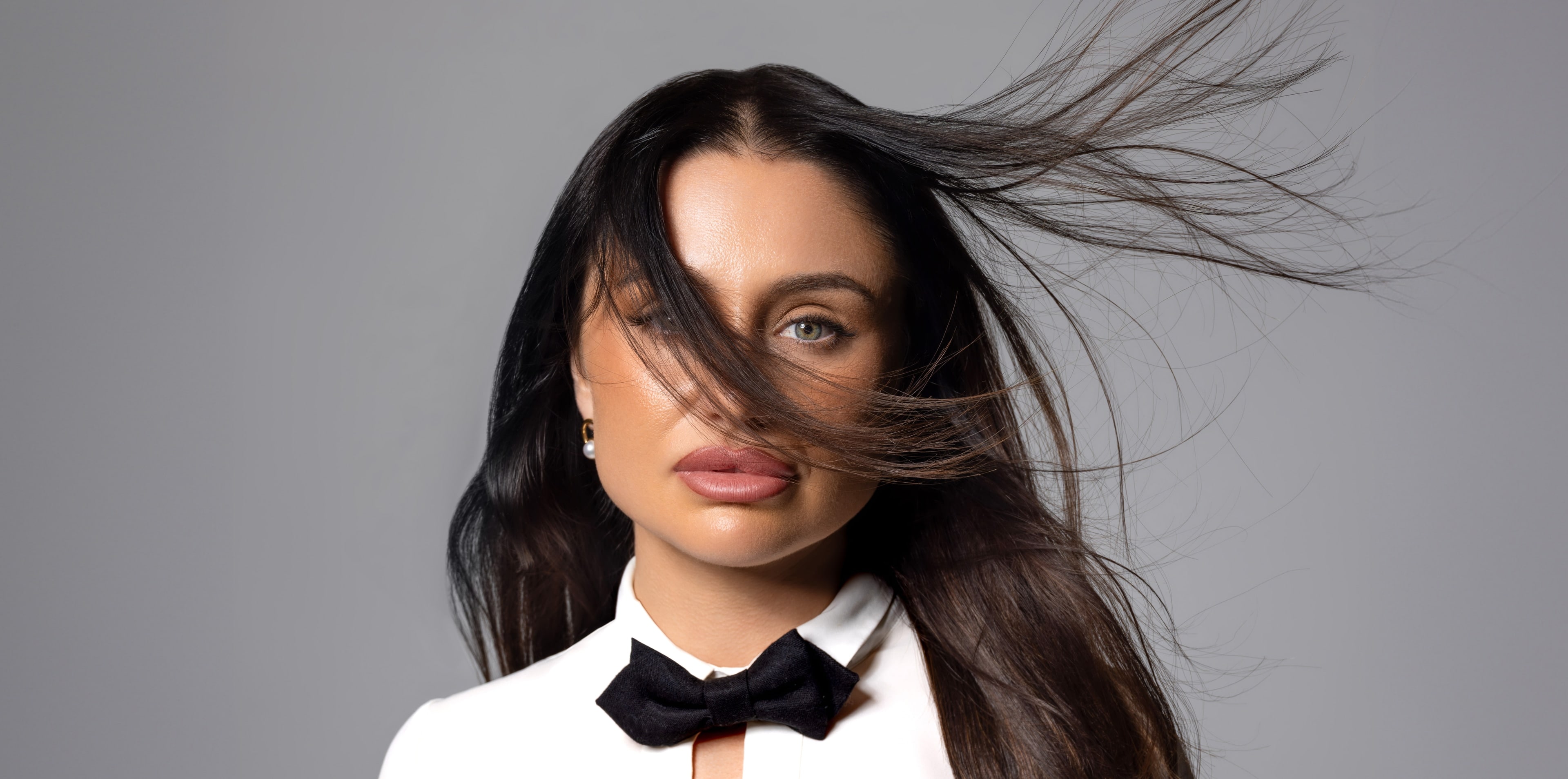 Fifi Rochet, photographer behind PLTFRM, hair in motion against a soft grey backdrop