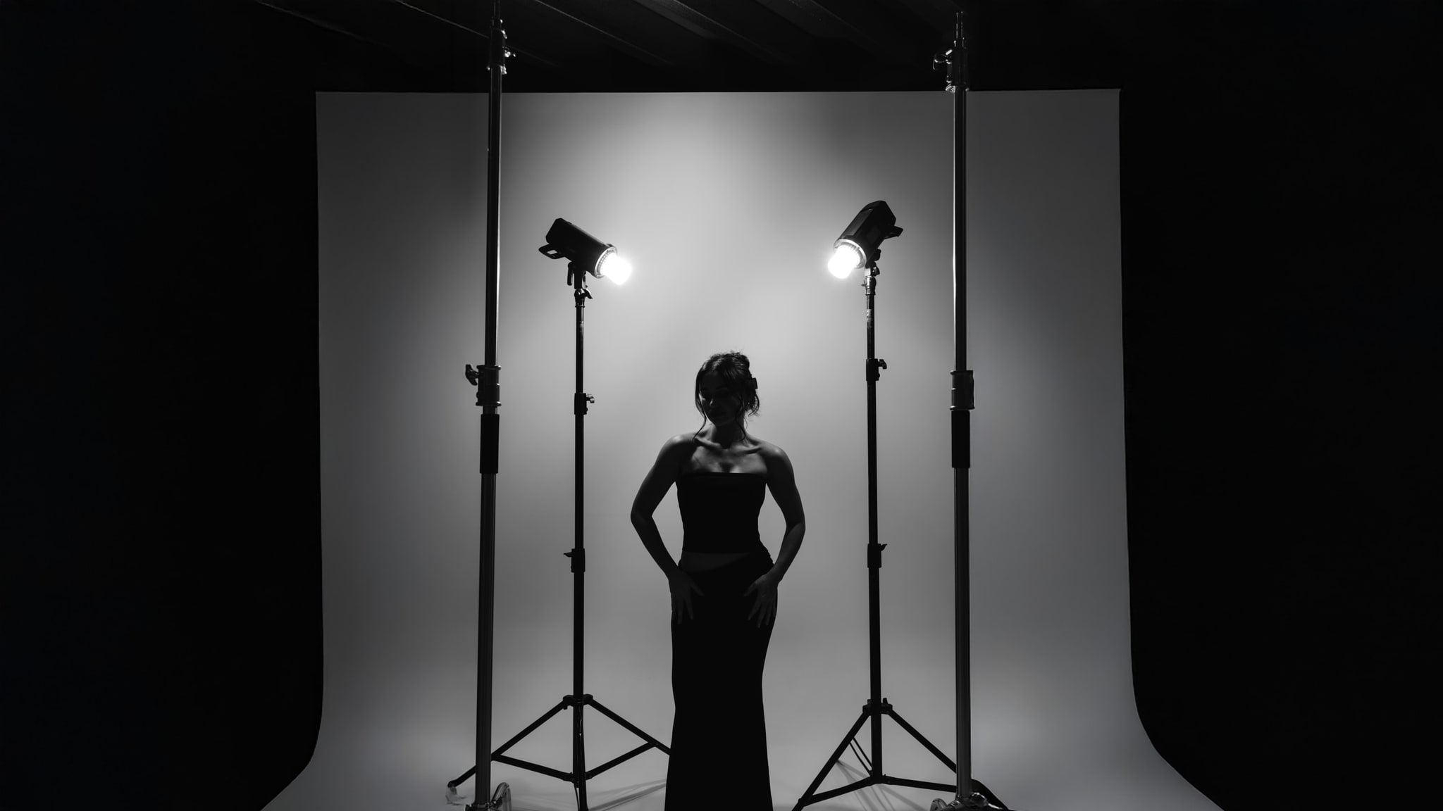 Fifi Rochet in silhouette on a studio set between two lights against a white seamless backdrop